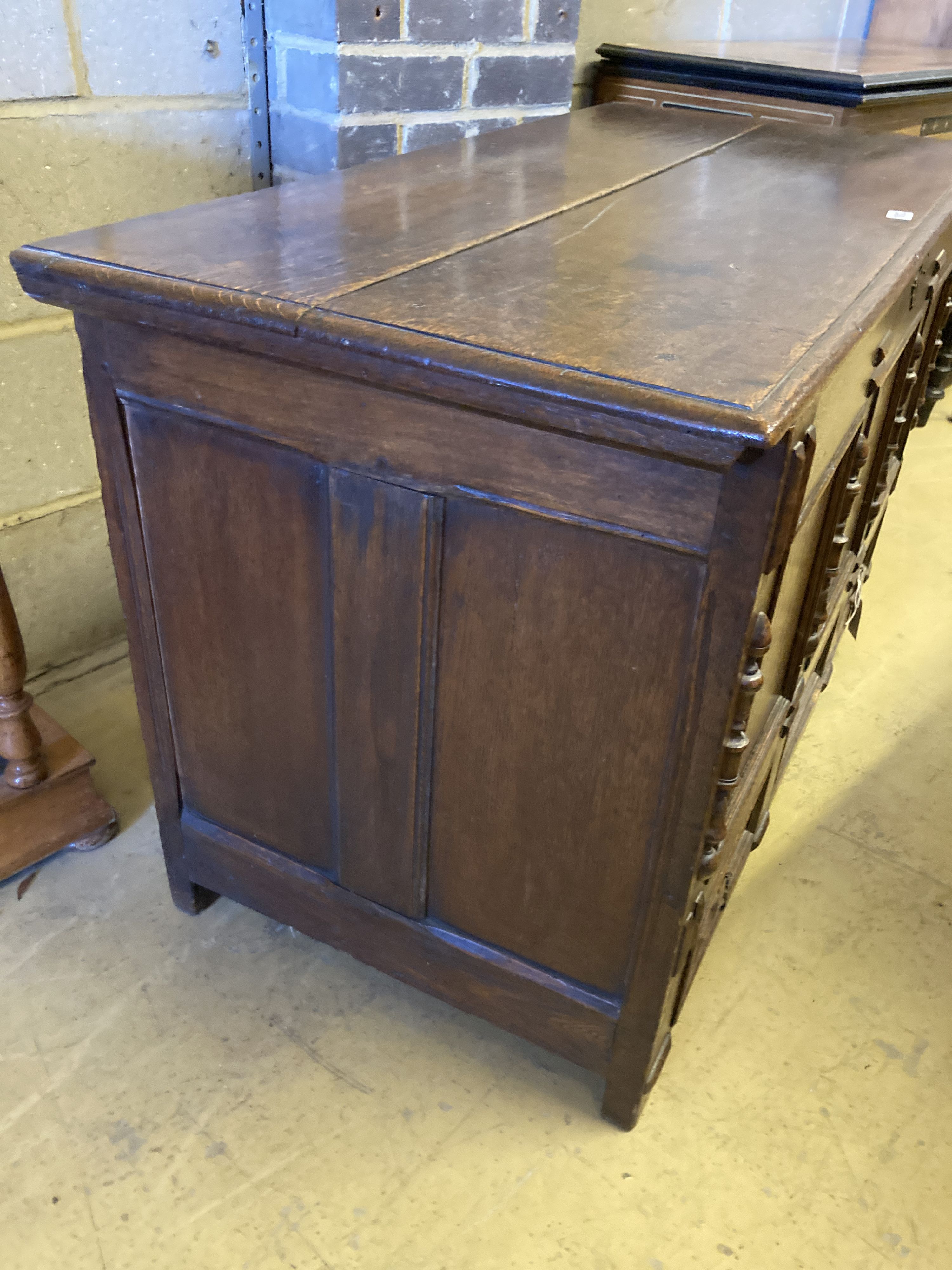 An 18th century panelled oak mule chest with planked top, length 118cm, depth 55cm, height 68cm